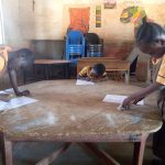 A student writing at a desk