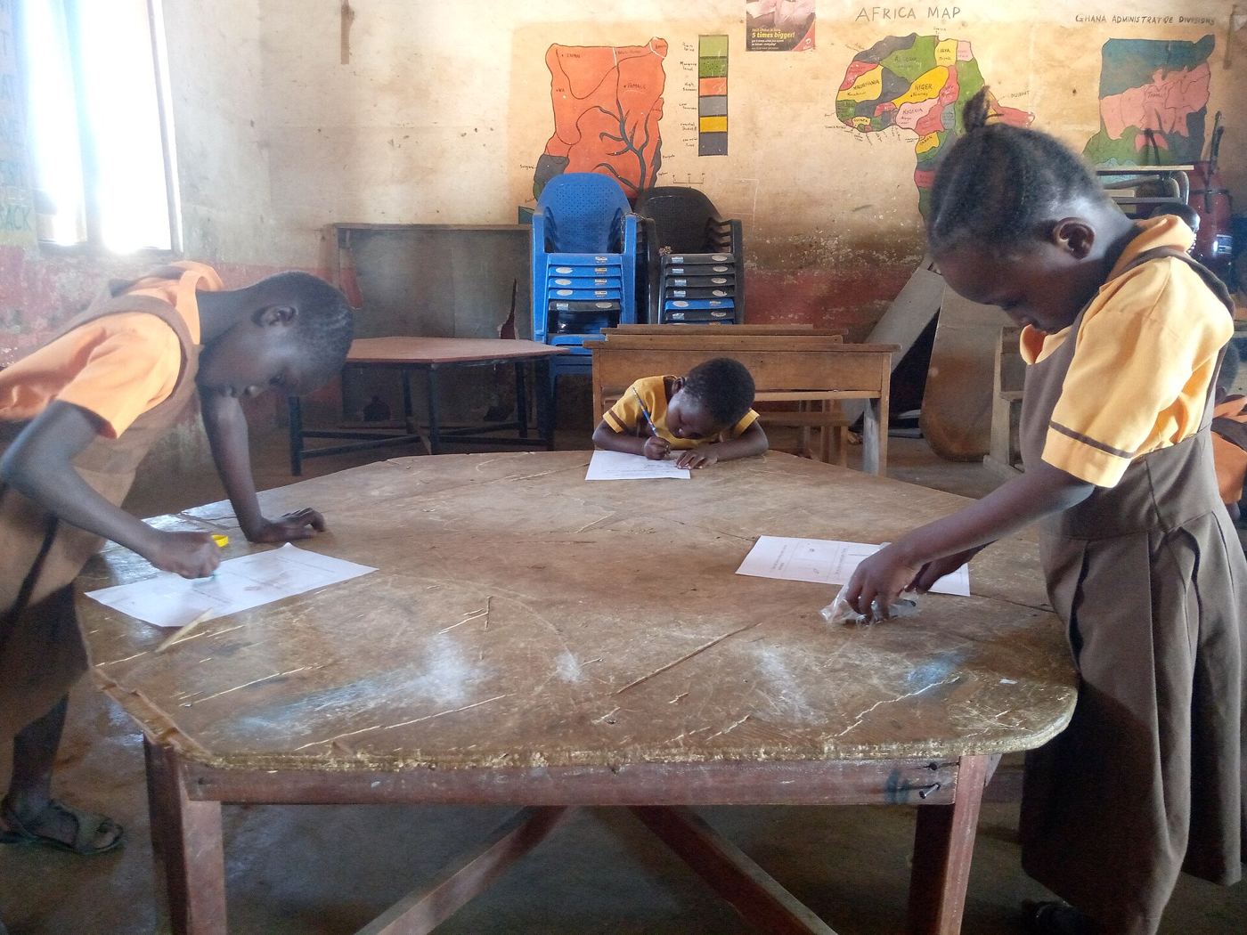 A student writing at a desk